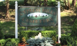 Cypress-Hills-Cemetery-Wooden-Sign-at-Entranceway